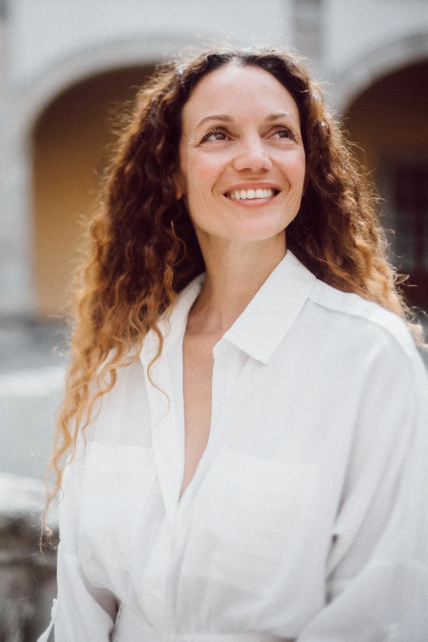 Ilhem smiling in a white shirt